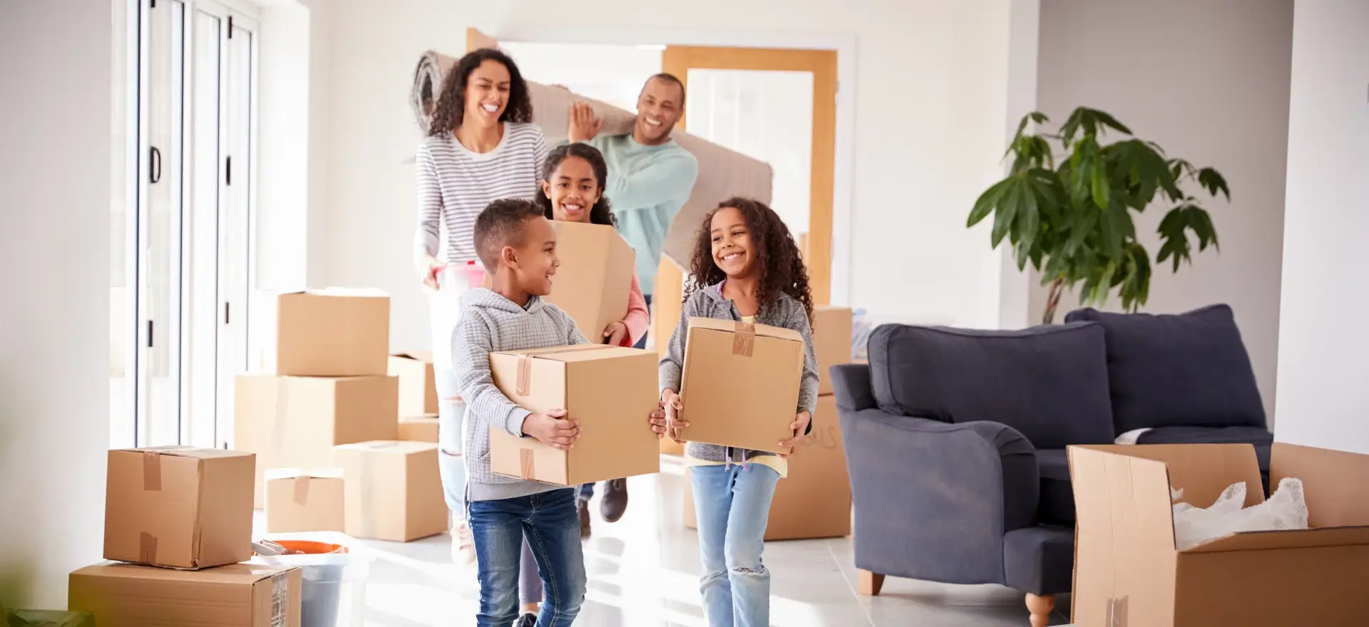 Happy family moving in to their new home thanks to First Secure Financial, LLC